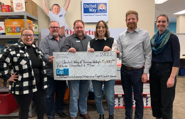 CapEd presenting a large check donation to United Way.