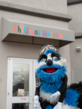Ed Word smiling outside the entrance of the Children's Museum of Idaho.
