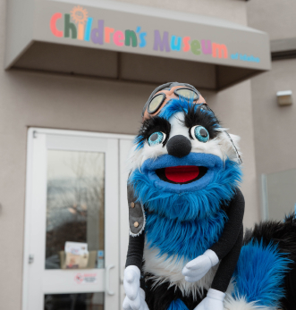 Ed Word smiling outside the entrance of the Children's Museum of Idaho.