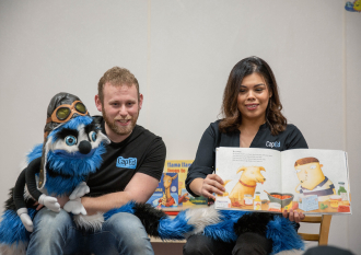 Ed Word reading a storybook to a group of children.